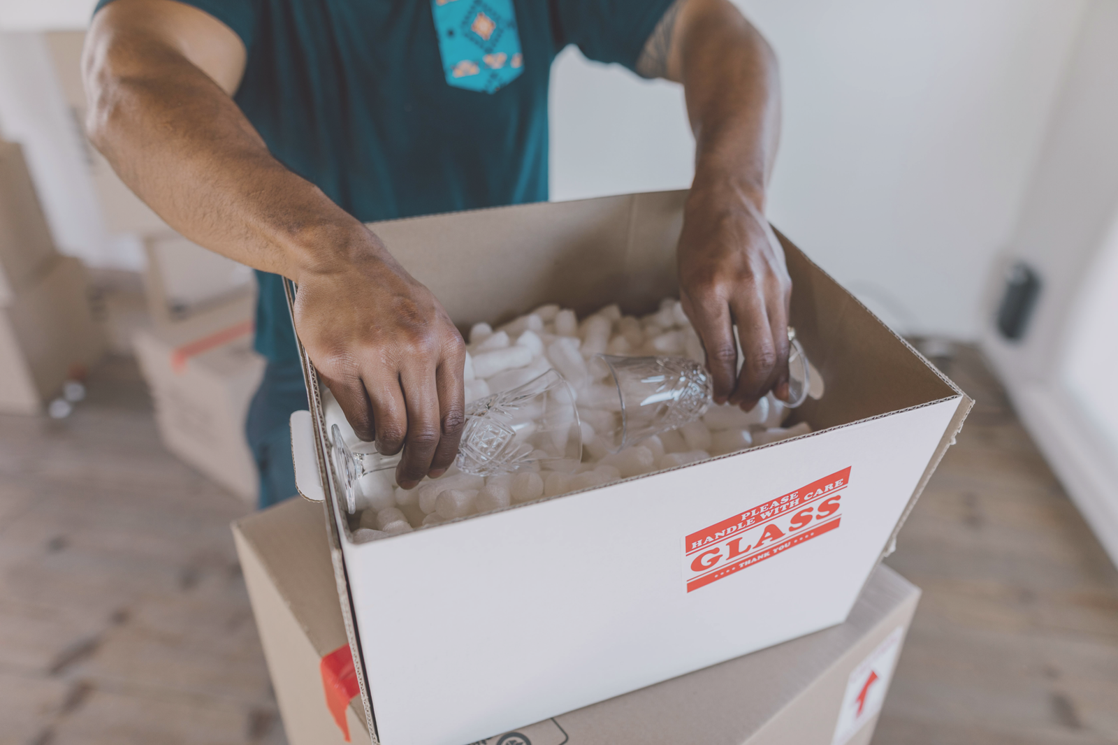 Removalists Rates Removalist carefully packing fragile items for a move